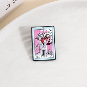 Enamel tarot brooch with The Patriarchy text and tower design on white tray