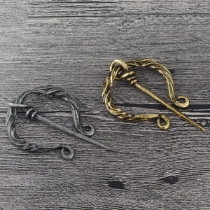 Détail macro de broches viking rétro en alliage avec texture torsadée en spirale