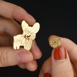 Detailed close-up of golden French Bulldog brooch back pin and butterfly clutch