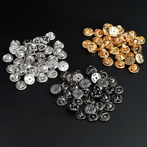 Detailed view of metal butterfly clutch pin backs in gold, silver, and gun black finishes