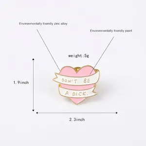 Pink heart enamel pin with 'DON'T BE A DICK' banner made of eco-friendly zinc alloy