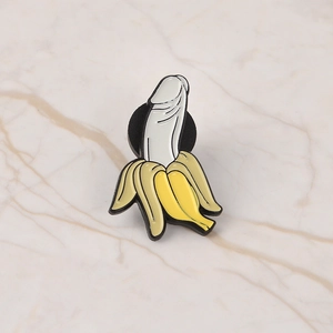 Creative enamel metal pin featuring a yellow peeled banana with a suggestive inner design