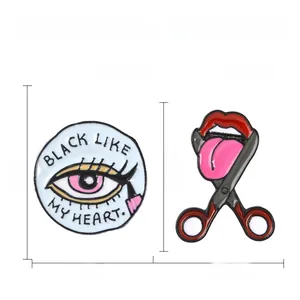 Detailed view of enamel badges with size specs and Black Like My Heart lettering