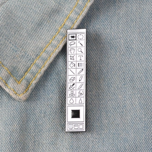 Creative enamel toolbar pin with classic software UI icons on blue denim jacket