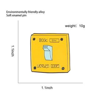 Detail showing 1.1x1.1 inch dimensions of yellow Book On enamel pin with blue switch