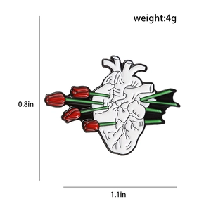 Detail of anatomical heart brooch with red tulips showing 1.1x0.8 inch dimensions