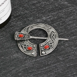 Antique silver Viking brooch with Celtic knot patterns and three red rubies inlay