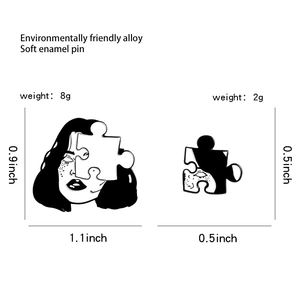 Detail view of puzzle head enamel pin set showing size 1.1x0.9 inch in black and white