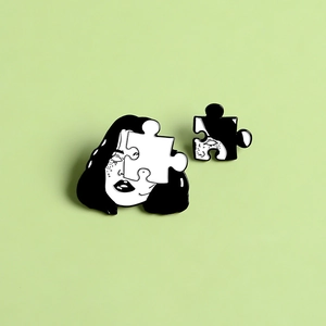 Detail of two-piece creative cartoon girl face jigsaw puzzle enamel brooch set in black and white