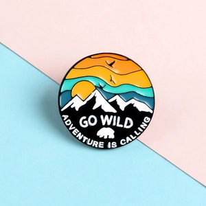 Sunset mountains enamel pin with bird and polar bear design for outdoor adventure