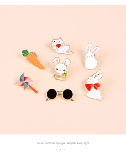 Detailed view of 7-piece cute cartoon enamel pins set including bunny, cat and windmill
