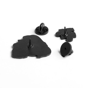 Black metal puzzle brooch backs and rubber pin clutch set on white background