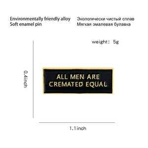 Black enamel brooch featuring gold text ALL MEN ARE CREMATED EQUAL in alloy frame