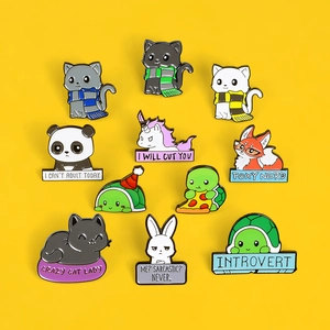 Detailed flat lay of 10 enamel pins with cute animals like fox and panda on yellow background
