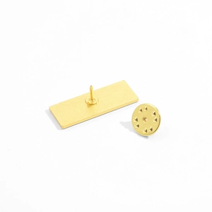 Golden alloy enamel pin back showing the rectangular base and butterfly clutch detail