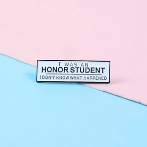 Close-up of funny rectangular enamel pin featuring Honor Student quote on colorful background
