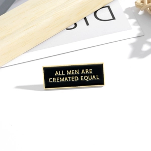 Rectangle black enamel lapel pin with gold All Men Are Cremated Equal engraving