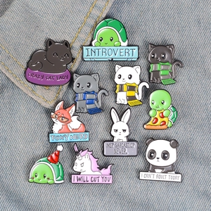 Cute cartoon animal enamel pins set on denim fabric featuring cat, turtle and panda designs