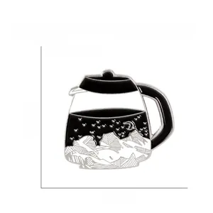 Detail showing an artistic enamel coffee pot brooch with mountain and moon landscape design