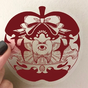 50 Gothic red apple PET stickers with paper-cut style held to show transparency