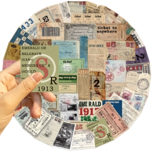 Detail shot of hand holding a green retro label from vintage paper scrapbooking kit