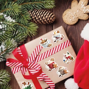 Christmas gingerbread man coffee stickers on gift box with festive holiday decorations