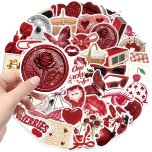Close-up of red Y2K aesthetic stickers featuring cherry, heart, and butterfly designs