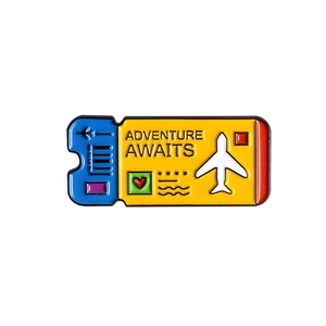 Detail view of enamel boarding pass pin with Adventure Awaits text and airplane motif