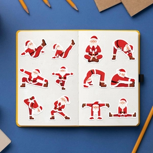 Flat lay of colorful yoga Santa stickers arranged on a yellow notebook for DIY decor