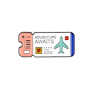 Detailed enamel boarding pass brooch with Adventure Awaits text and airplane icon