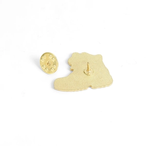 Golden hiking boot brooch pin back view with metal clutch on plain white background