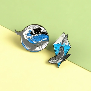Detailed close-up of cartoon whale enamel pins in circular and diamond shapes