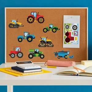 Cartoon farm vehicle stickers displayed on a corkboard with stationery surroundings