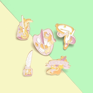 Artistic enamel lapel pins with palette, paintbrushes, and melting clock designs