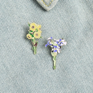 Artistic Van Gogh inspired sunflower and iris enamel brooch pin set on denim jacket