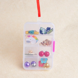 Transparent 8-grid plastic storage box for brooches and jewelry with pink buckle and red lanyard