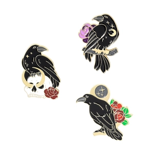 Gothic black raven enamel brooches with skull and roses on a white background
