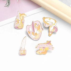 Five-piece artistic enamel pin set with paintbrush and dream-themed design in pink gold
