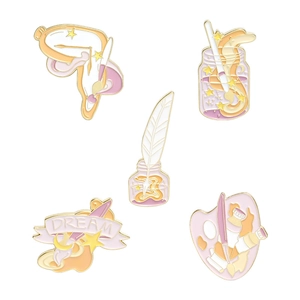Detail view of five artistic enamel pins featuring paint palettes and brushes in gold trim