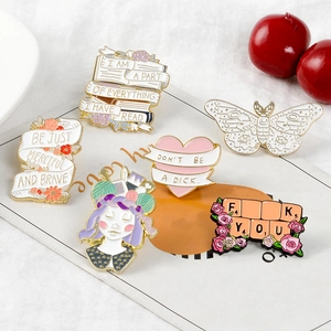 Close-up of high-quality enamel brooch pins featuring creative butterfly and heart patterns