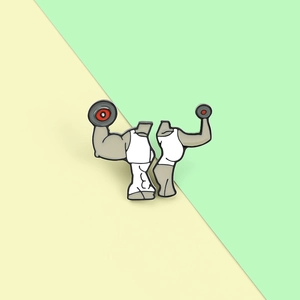 Detailed macro view of creative enamel fitness brooches featuring two weightlifting muscle figures