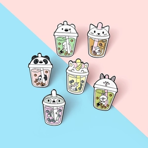 Detailed close-up of six enamel pins featuring cute animals in bubble tea cups