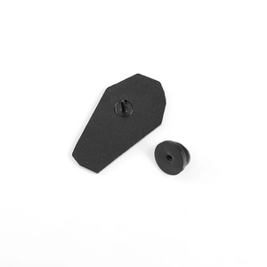 Detail of black coffin shaped metal enamel pin back with black rubber clutch closure