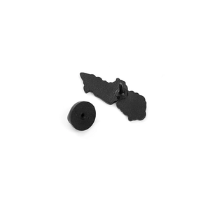 Detailed macro view of metal pin back with black matte finish and rubber clutch attachment
