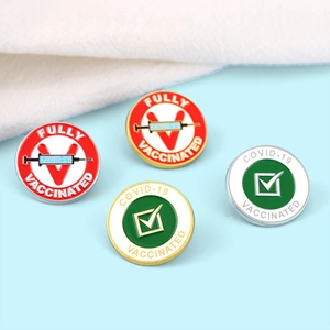 Set of four colorful enamel medical vaccine pins with syringe and checkmark icons