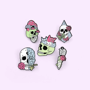 Set of five gothic enamel skull brooches with mushroom and rose designs in pastel colors