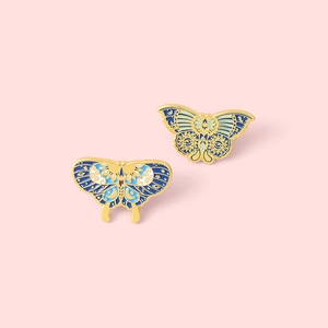 Enamel butterfly brooch set with gold metal outlines and celestial moon star patterns