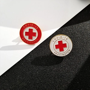 Detail of COVID-19 Vaccinated enamel pins with red cross and secure butterfly clutch back
