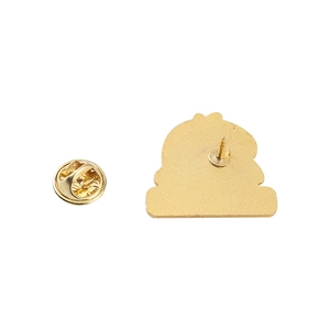 Detailed macro view of the golden alloy brooch backplate with a butterfly clutch pin