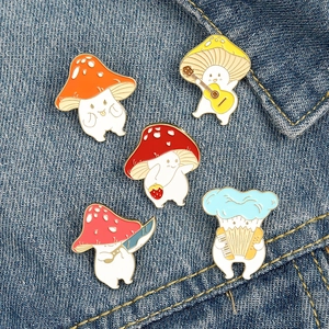Five cute enamel mushroom pins with musical instruments and fruits on denim jacket